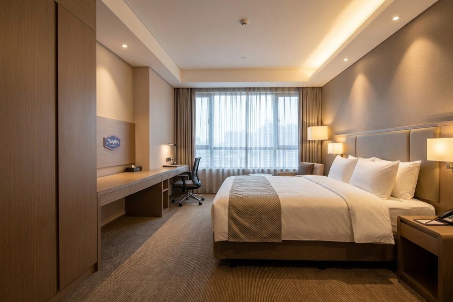Hampton Inn USA guestroom showing manufactured FF&E casegoods and branded hotel furniture